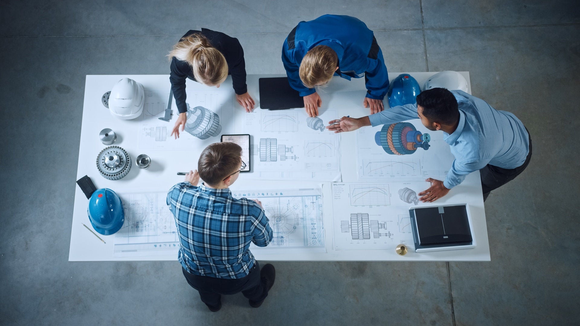 Team of Industrial Engineers Lean on Office Table, Analyze Machinery Blueprints, Architectural Problem Solving, Consult Project on Tablet Computer, Inspect Metal Component. Flat Lay Top Down View; Shutterstock ID 1902078577; purchase_order: -; job: -; Name of competition (if applicable): -; other: -