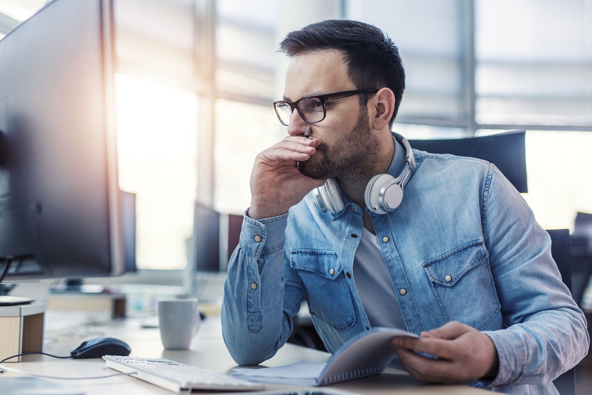 Modern young focused programmer working hard at he office